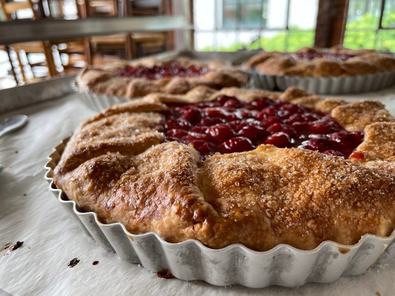 A whole rustic sour cherry pie in a fluted pan