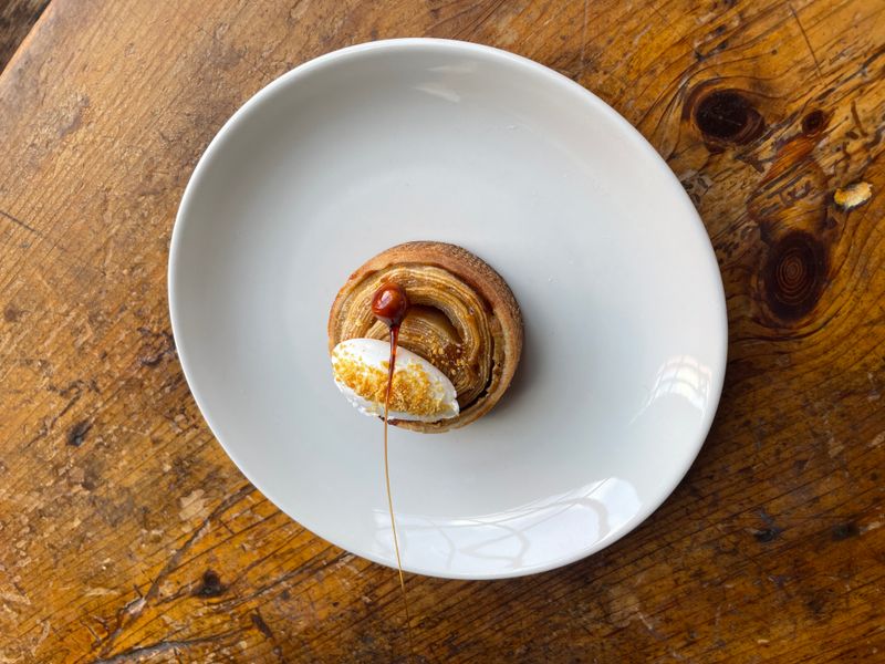 Plated pastry with ice cream and caramel on a white plate