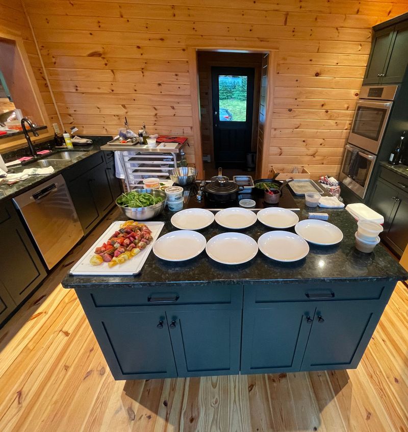 Plates set out on the kitchen island, ready for plating
